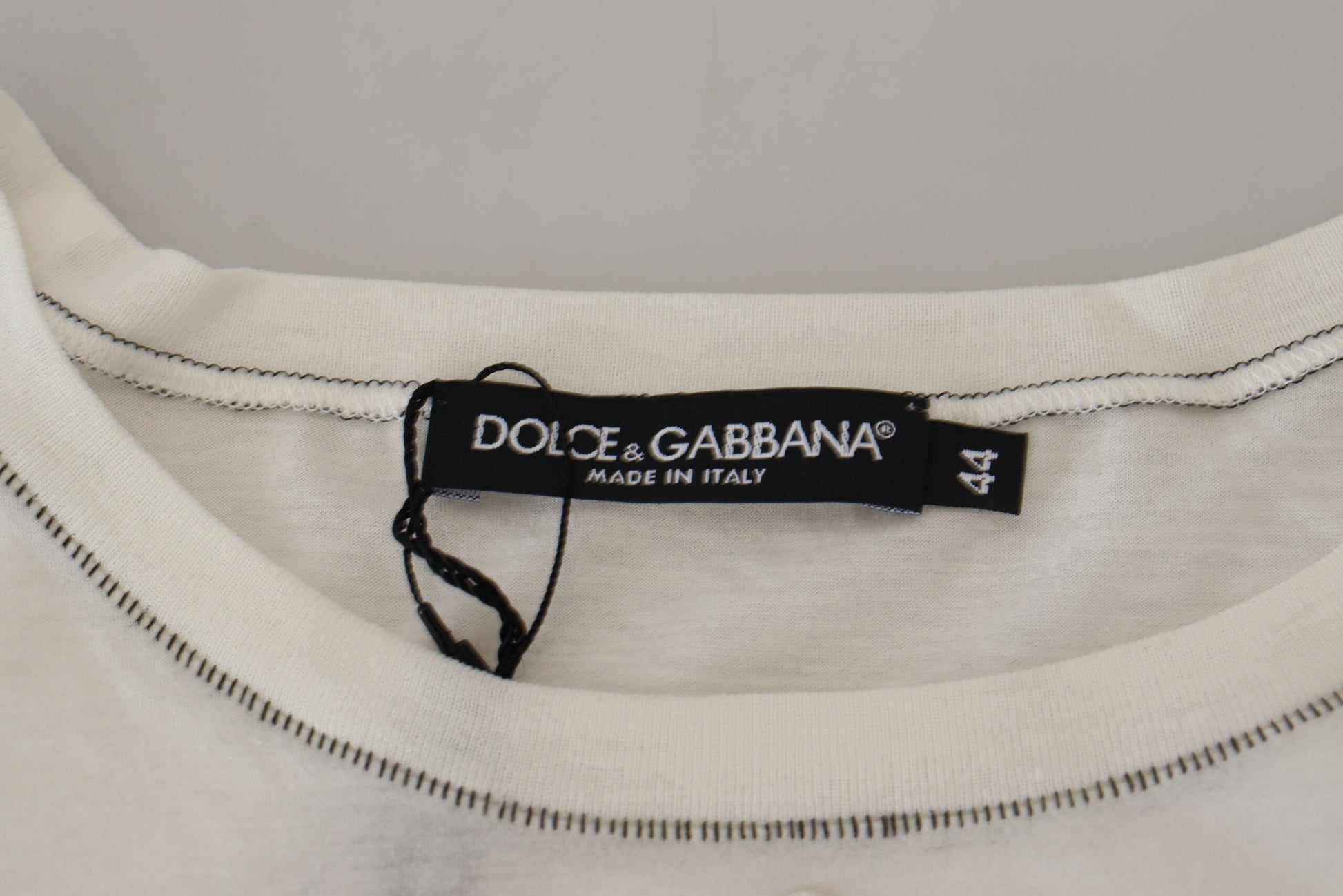 White garment with zipper tagged "Dolce & Gabbana made in Italy"