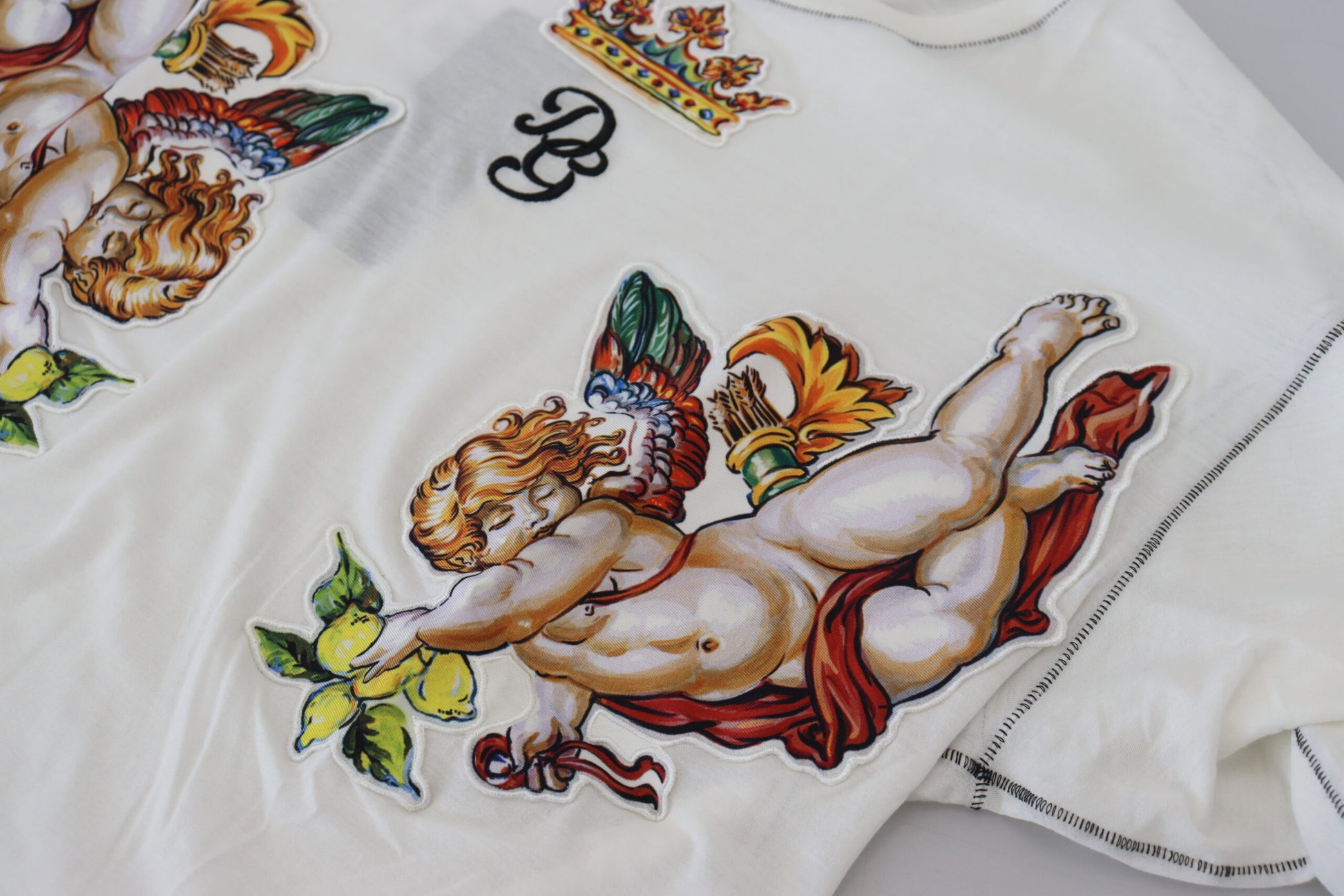White garment with embroidered angel design
