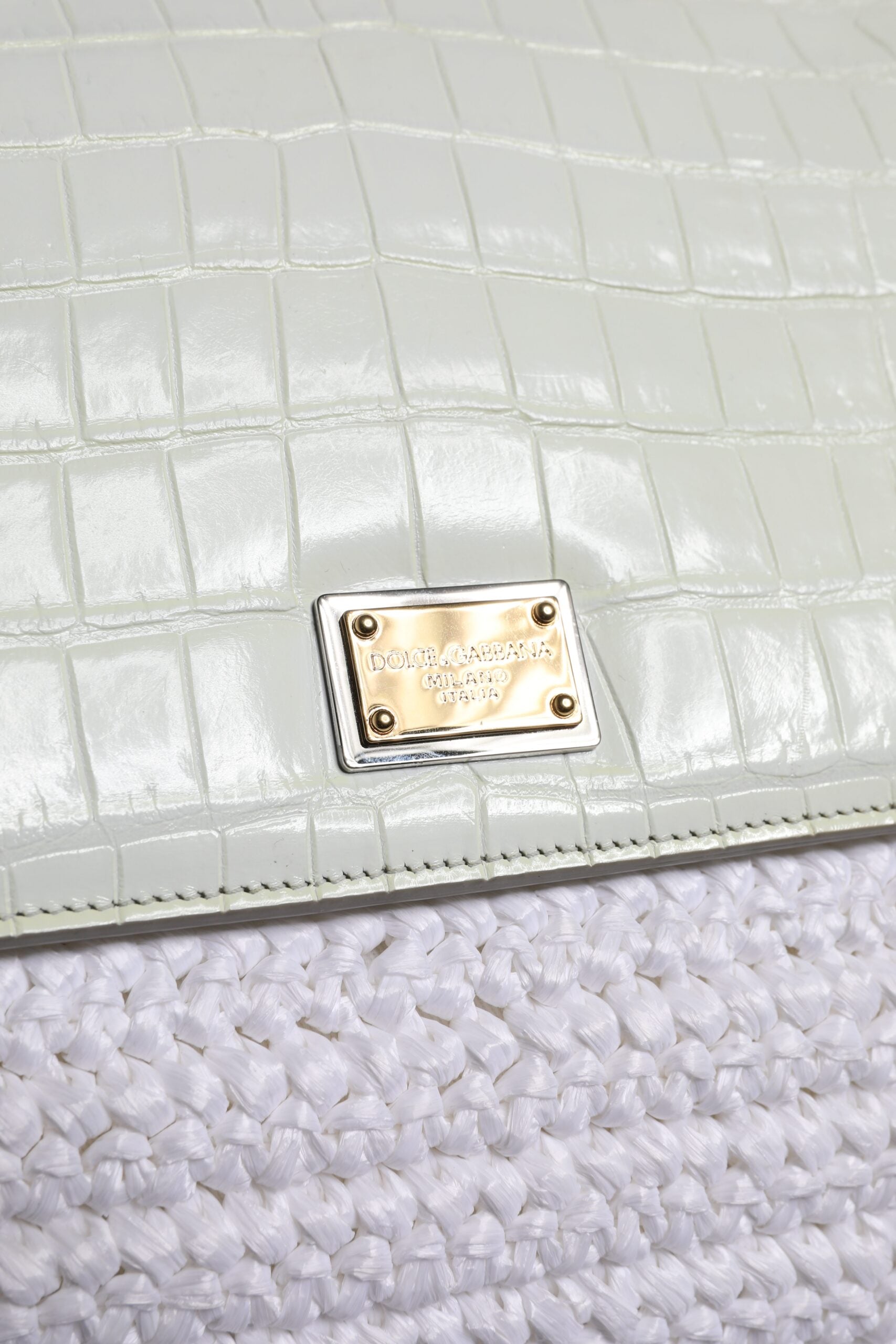 Small leather wallet with a gold logo on the front