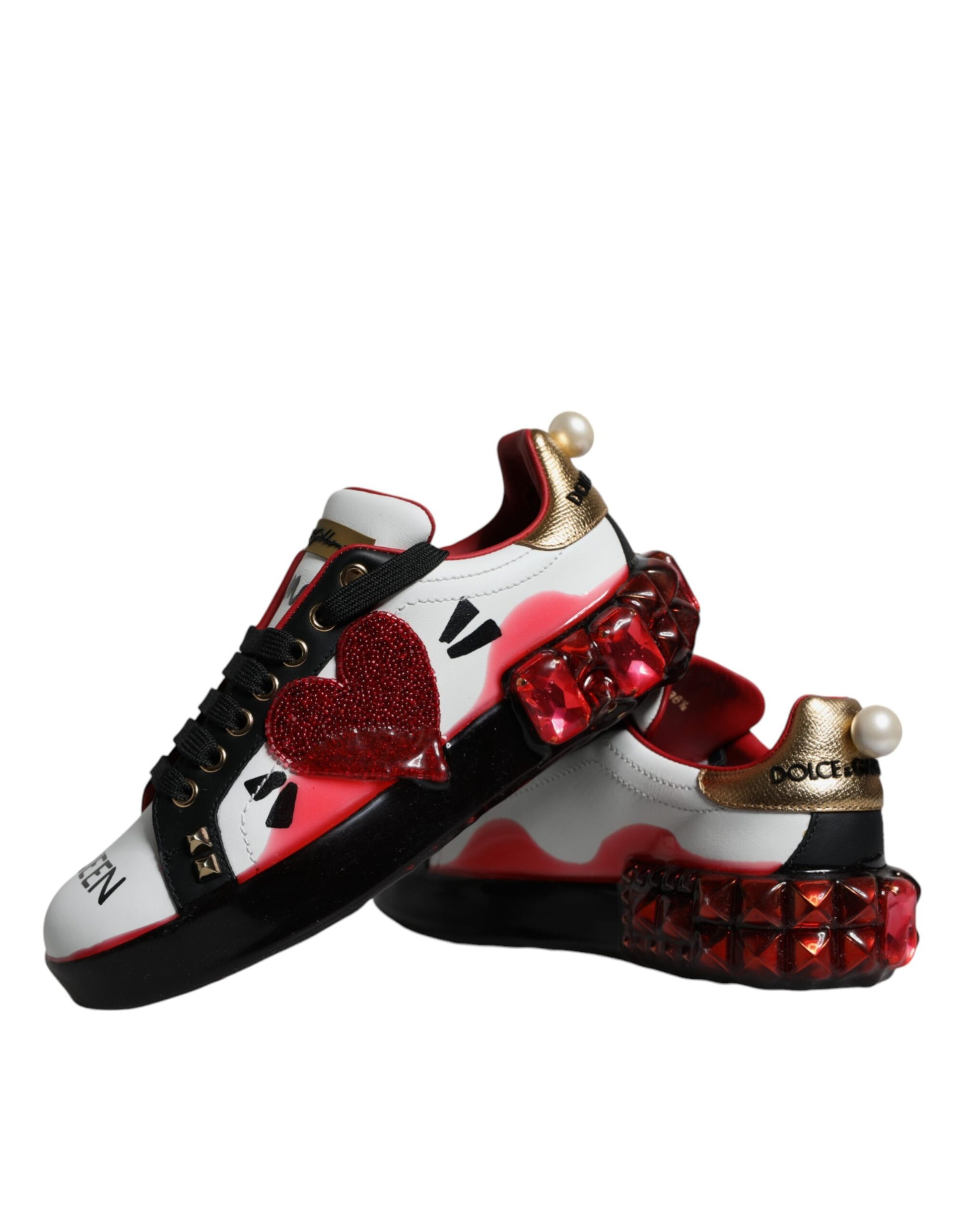 Pair of sneakers with red and white design featuring hearts and spikes