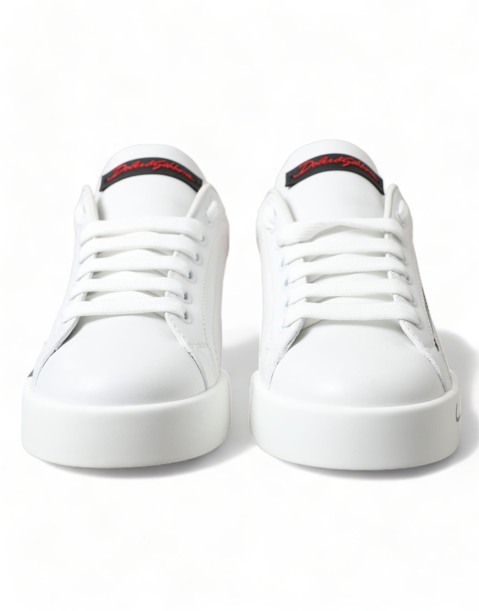 Pair of white sneakers with red accents and a black sole