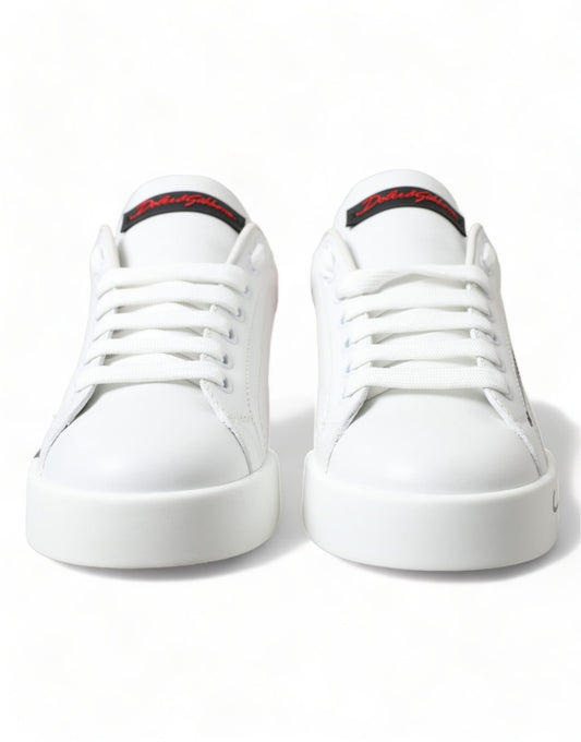 Pair of white sneakers with red accents and a black sole