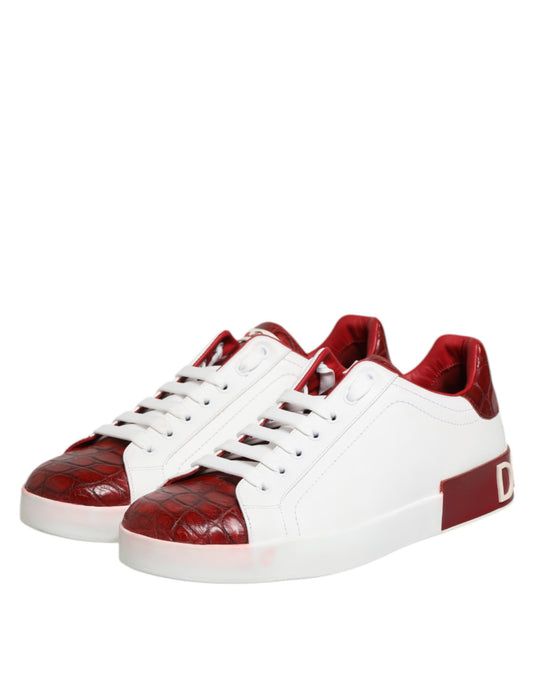 Pair of red and white leather sneakers with laces, featuring a distinctive design
