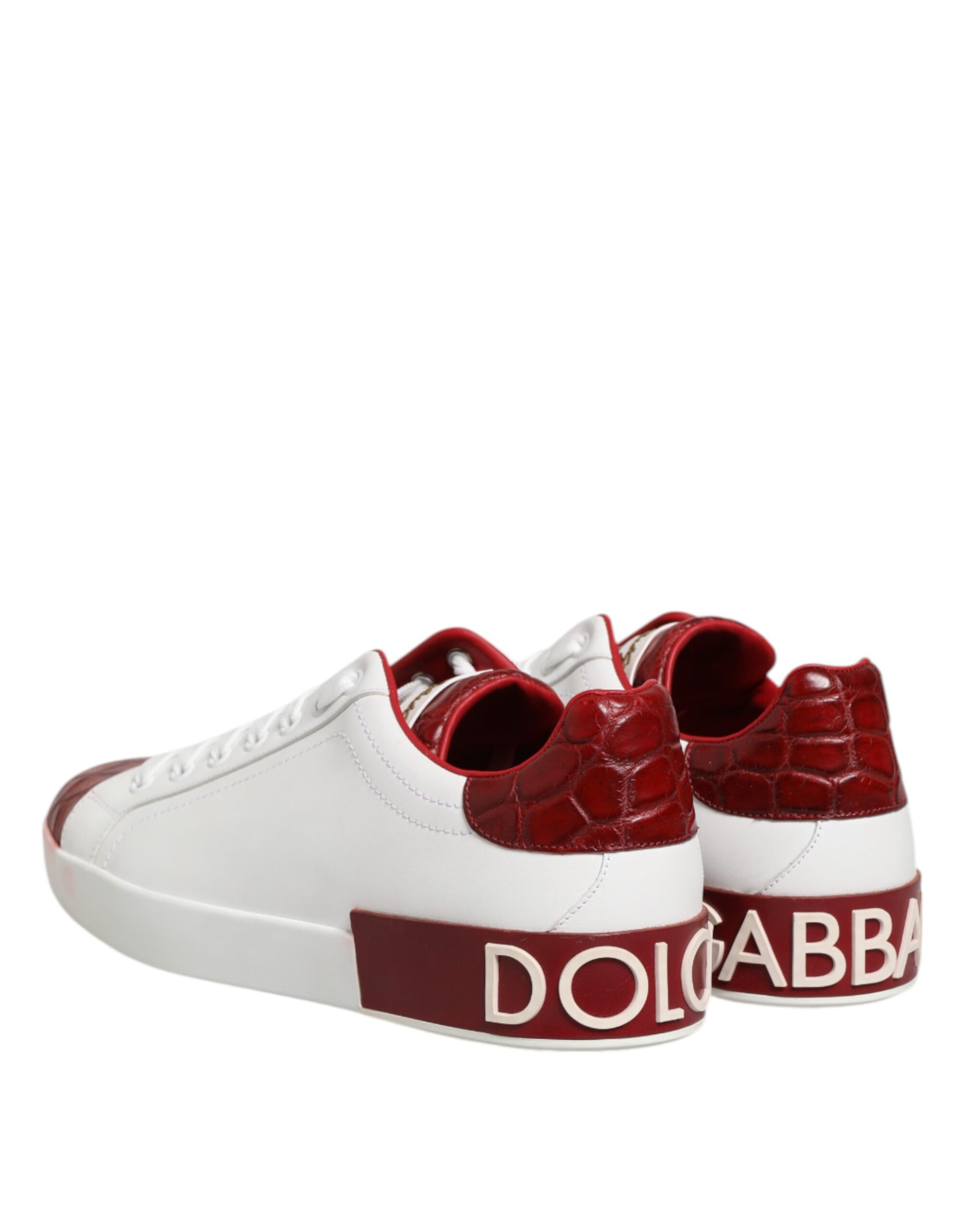 Pair of red and white leather sneakers with laces, featuring the brand name "Dolce & Gabbana" on side