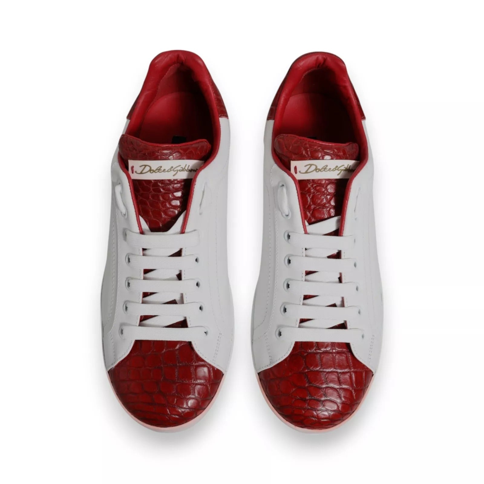 Pair of red and white leather sneakers with a logo on the side, featuring a lace-up design