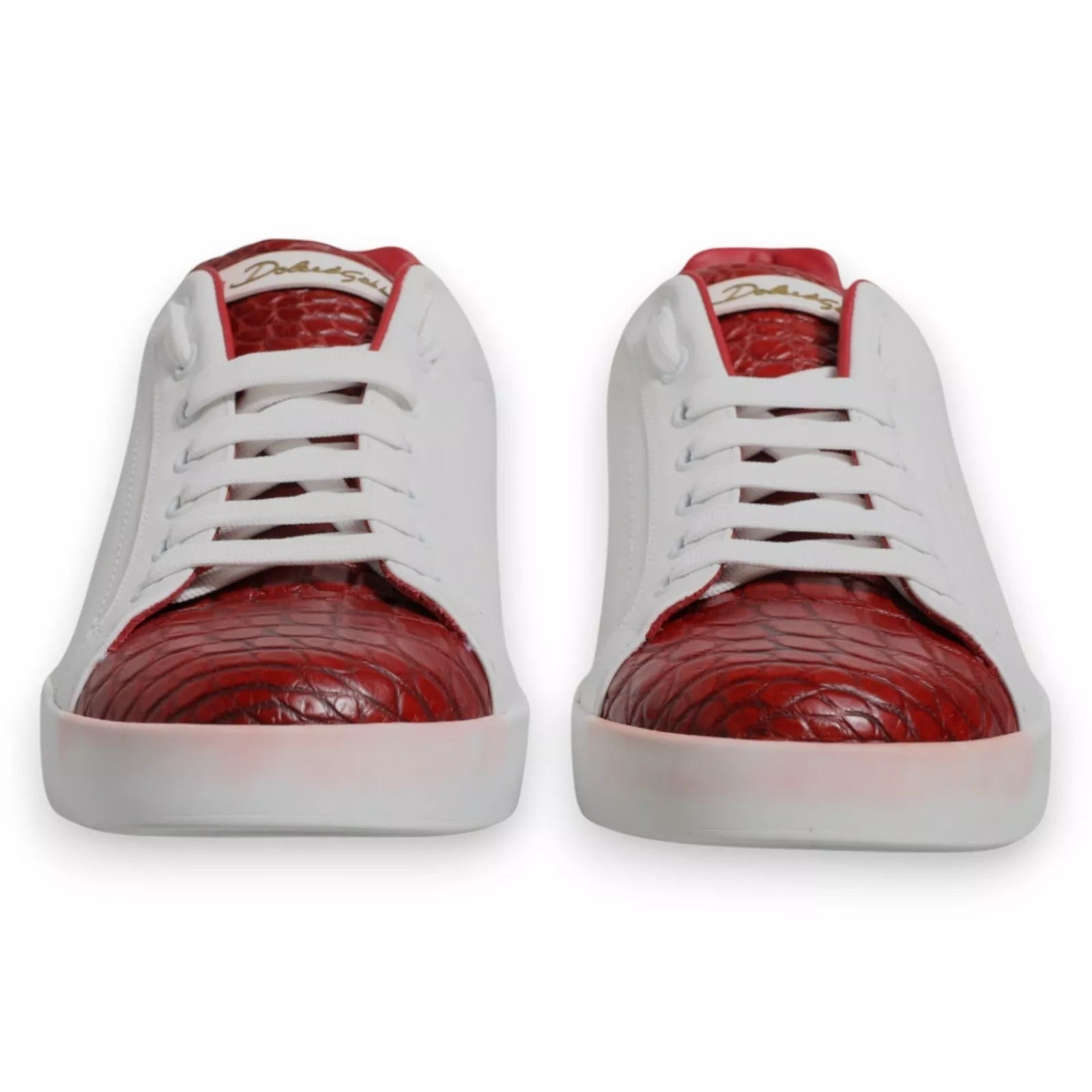 A pair of red and white sneakers with a leather logo on the side