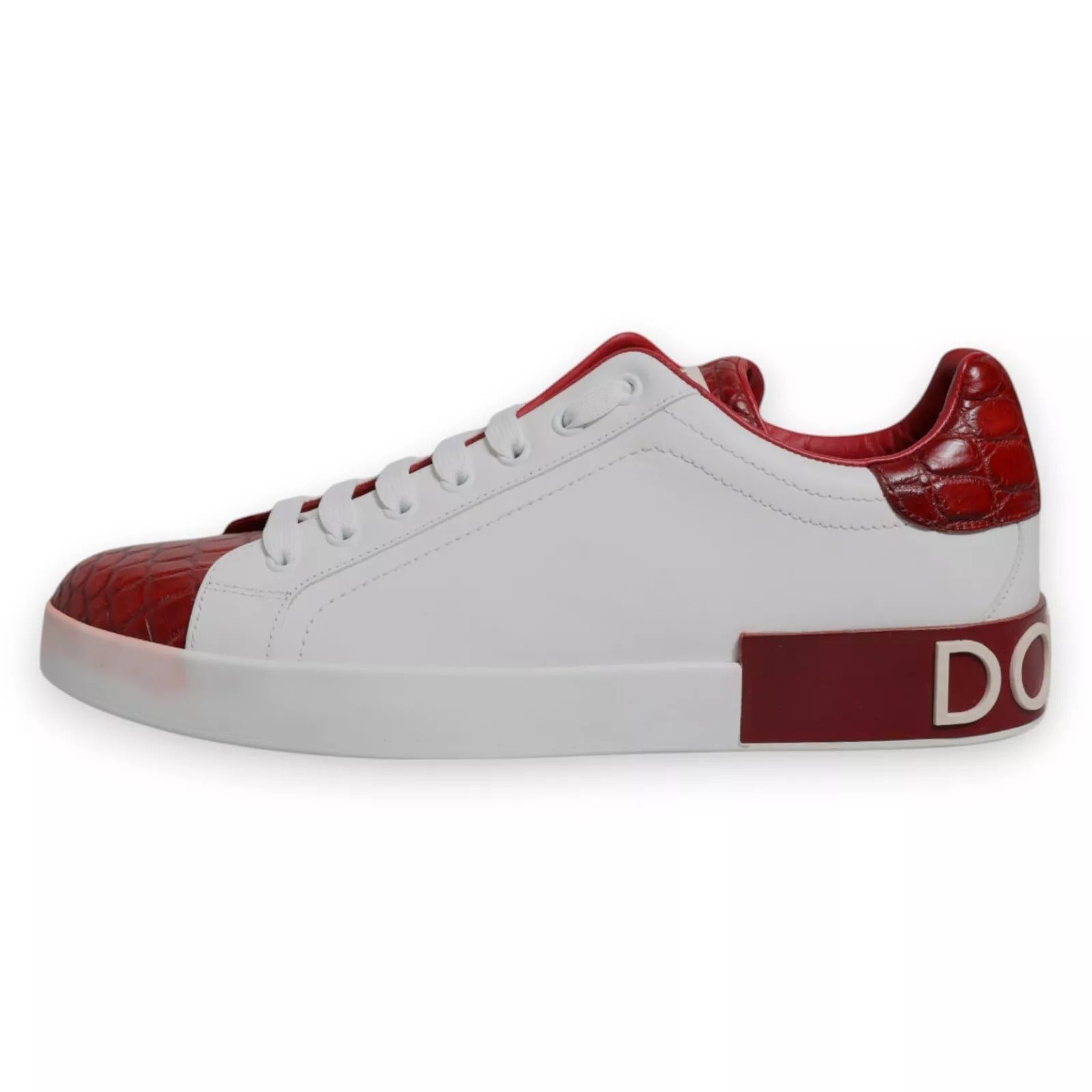 A white red leather sneaker with a logo on the side, featuring a lace-up design and a chunky sole