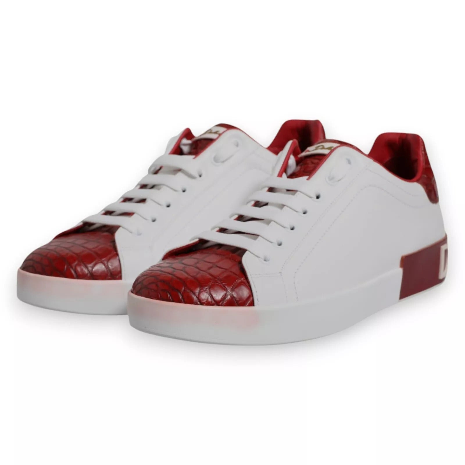 A pair of red and white leather sneakers with a logo on the side, featuring a quilted design
