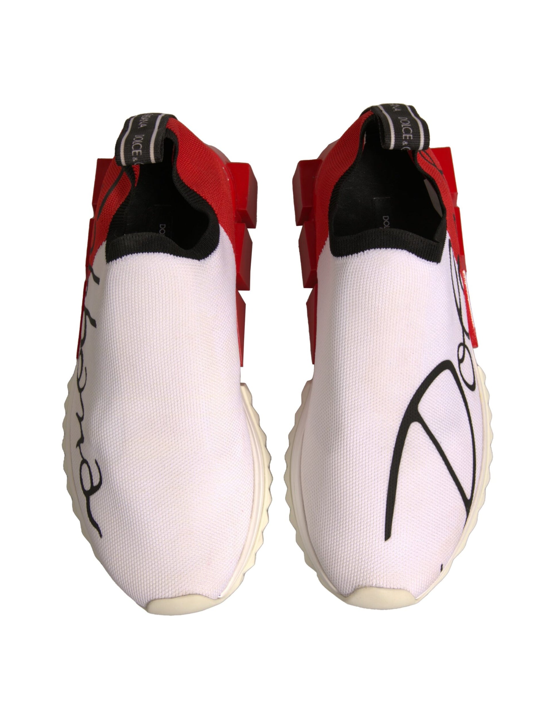 Pair of white sneakers with red accents and black laces