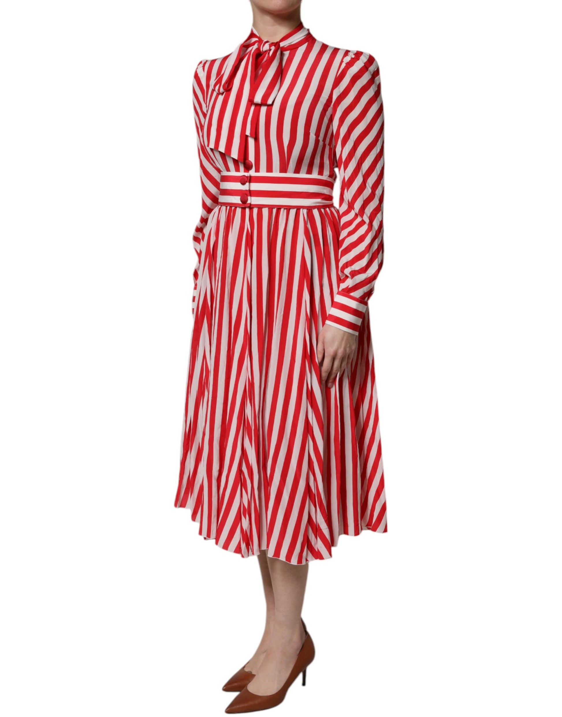 A woman wearing a red and white striped midi dress with long sleeves
