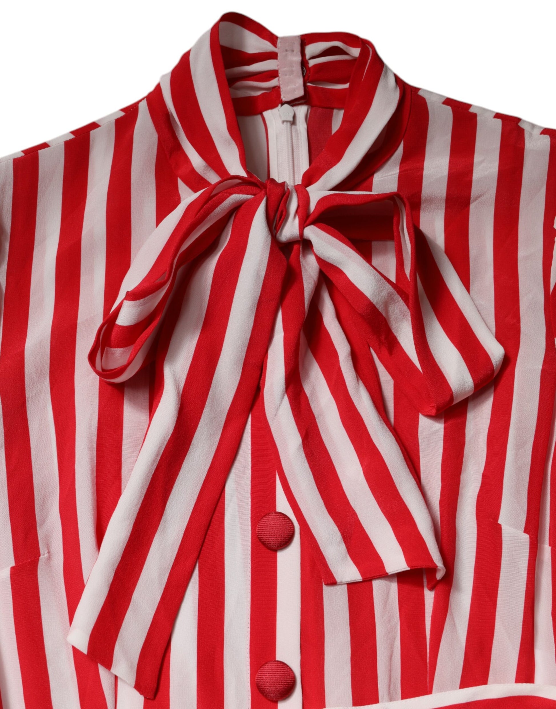 A red and white striped midi dress with long sleeves, featuring a bow tie