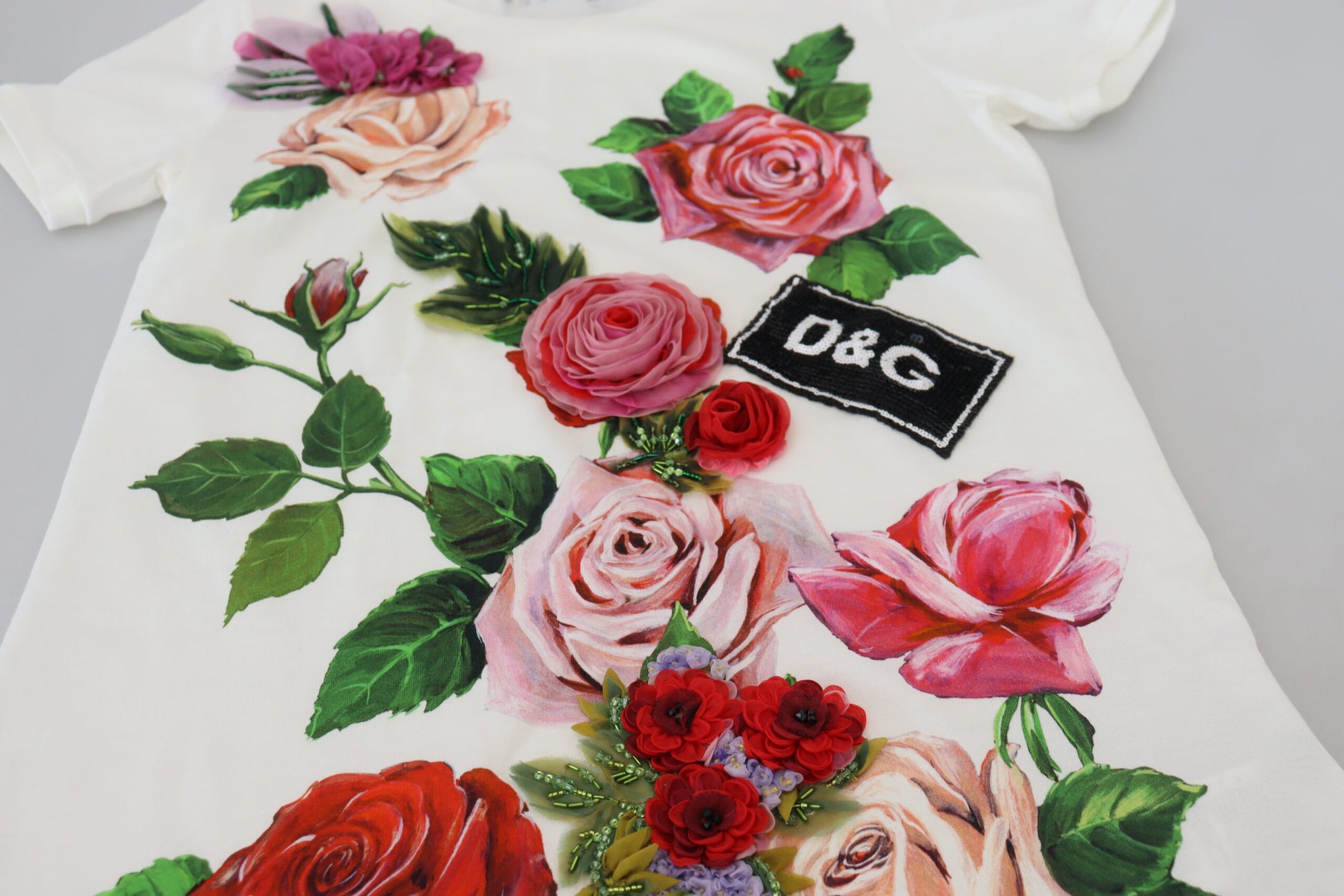 Floral print t-shirt with pink roses on a white background