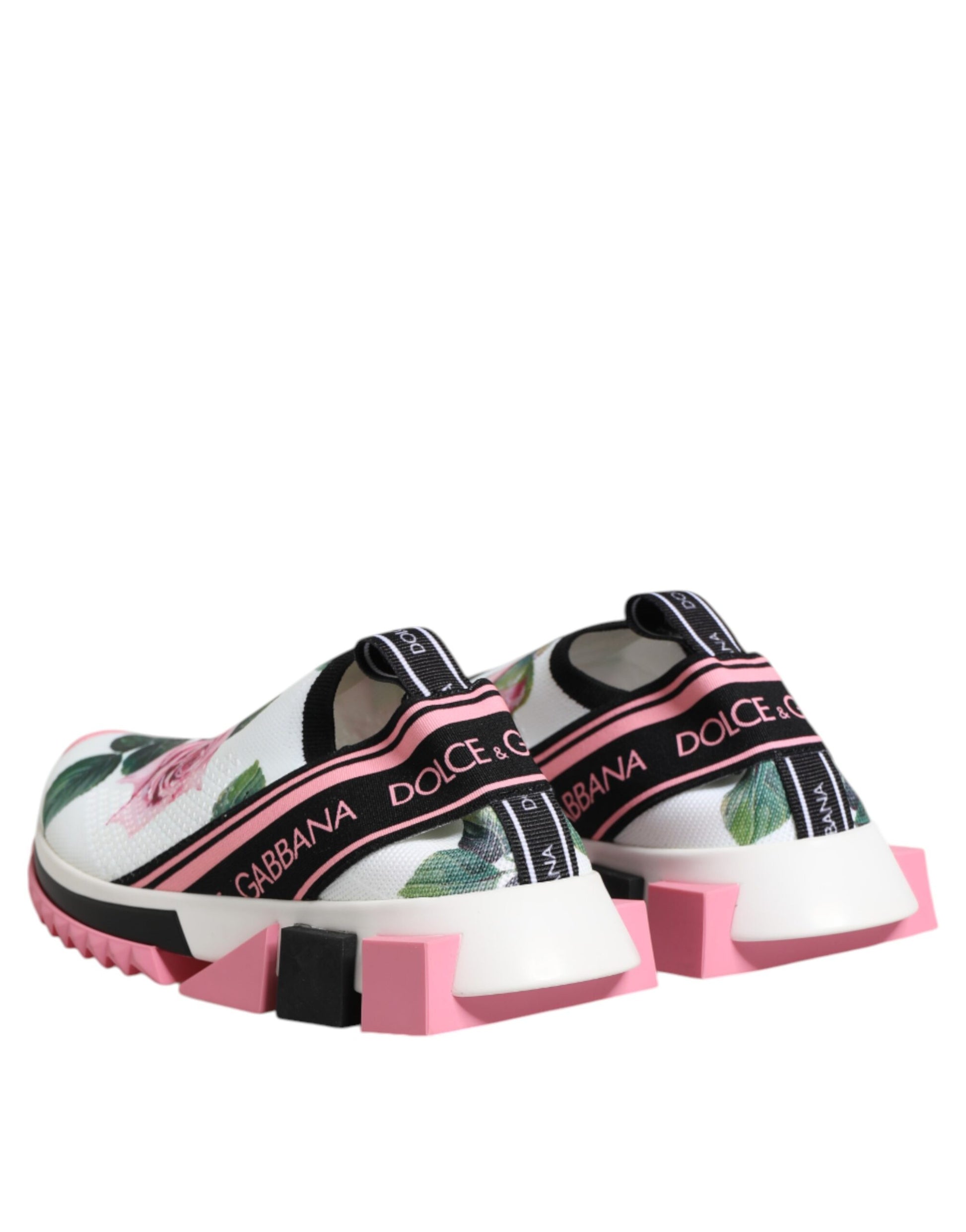 Pair of pink and white slip on shoes with floral pattern