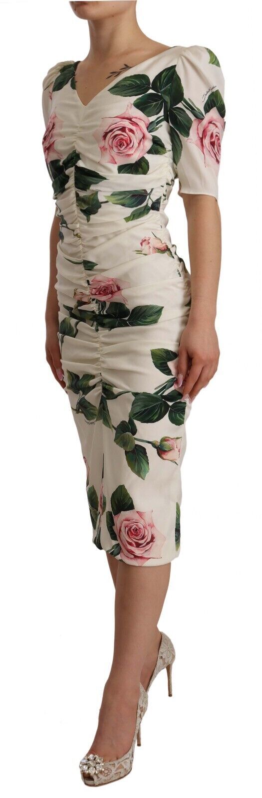 A woman's dress with a white roses print and pleated design, made of stretch silk