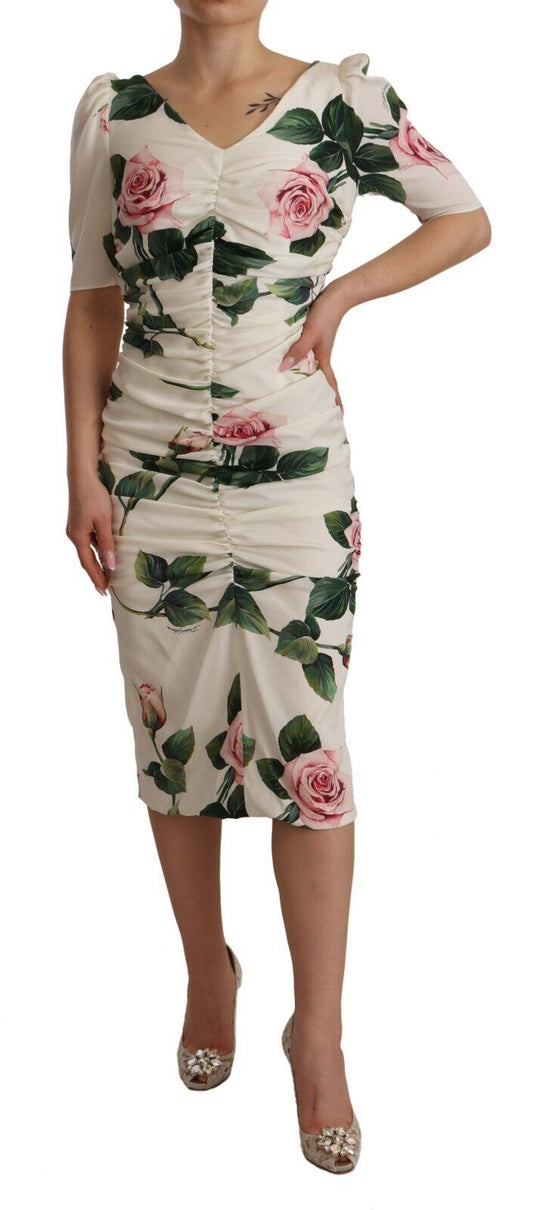 A woman wearing a white dress with floral print and pleats