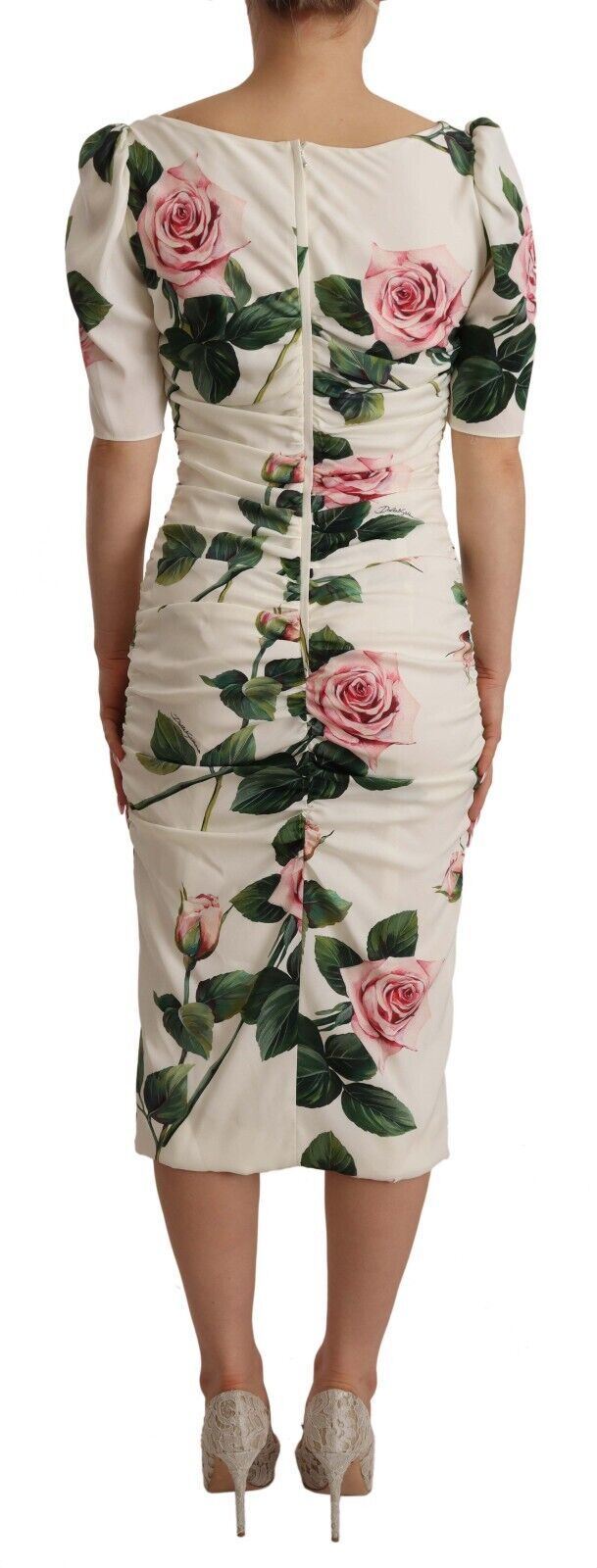 A white dress with a floral print of pink roses on the bodice and sleeves