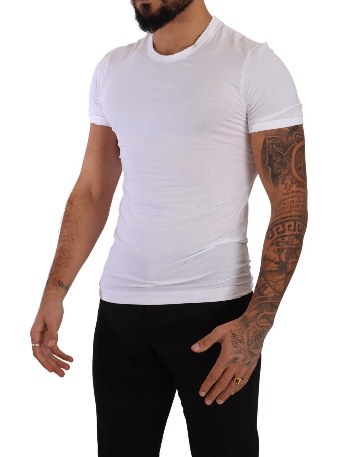 Man wearing white t-shirt and showing tattoos on arms