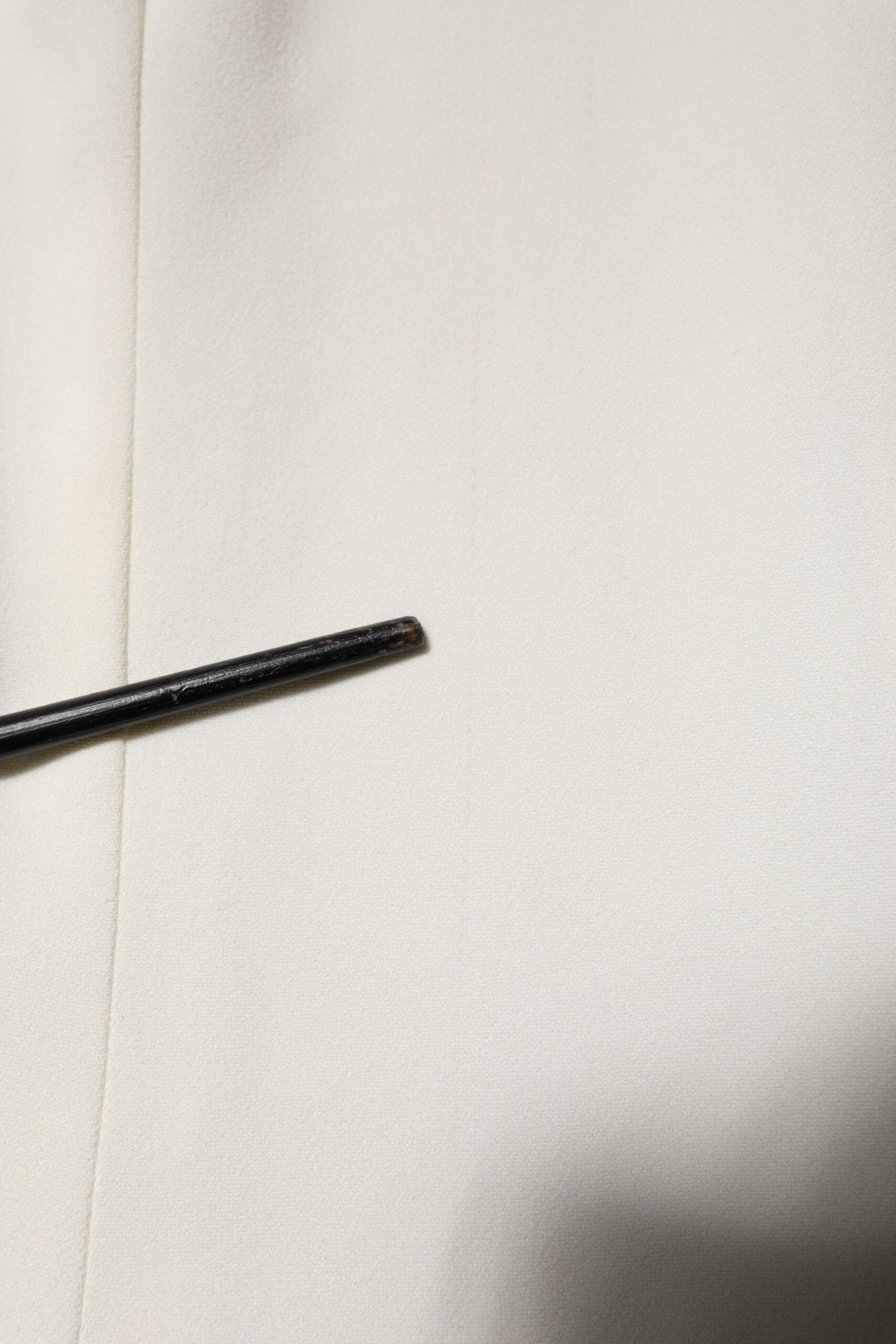 Black pin on white fabric