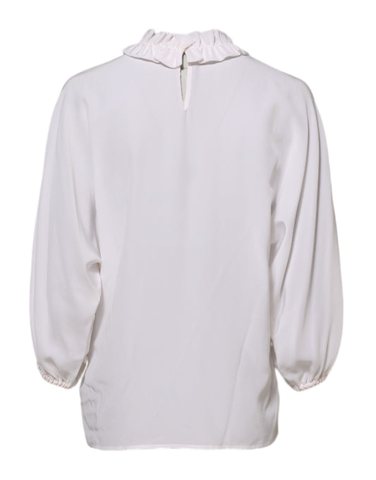Long sleeved pink shirt with ruffled collar