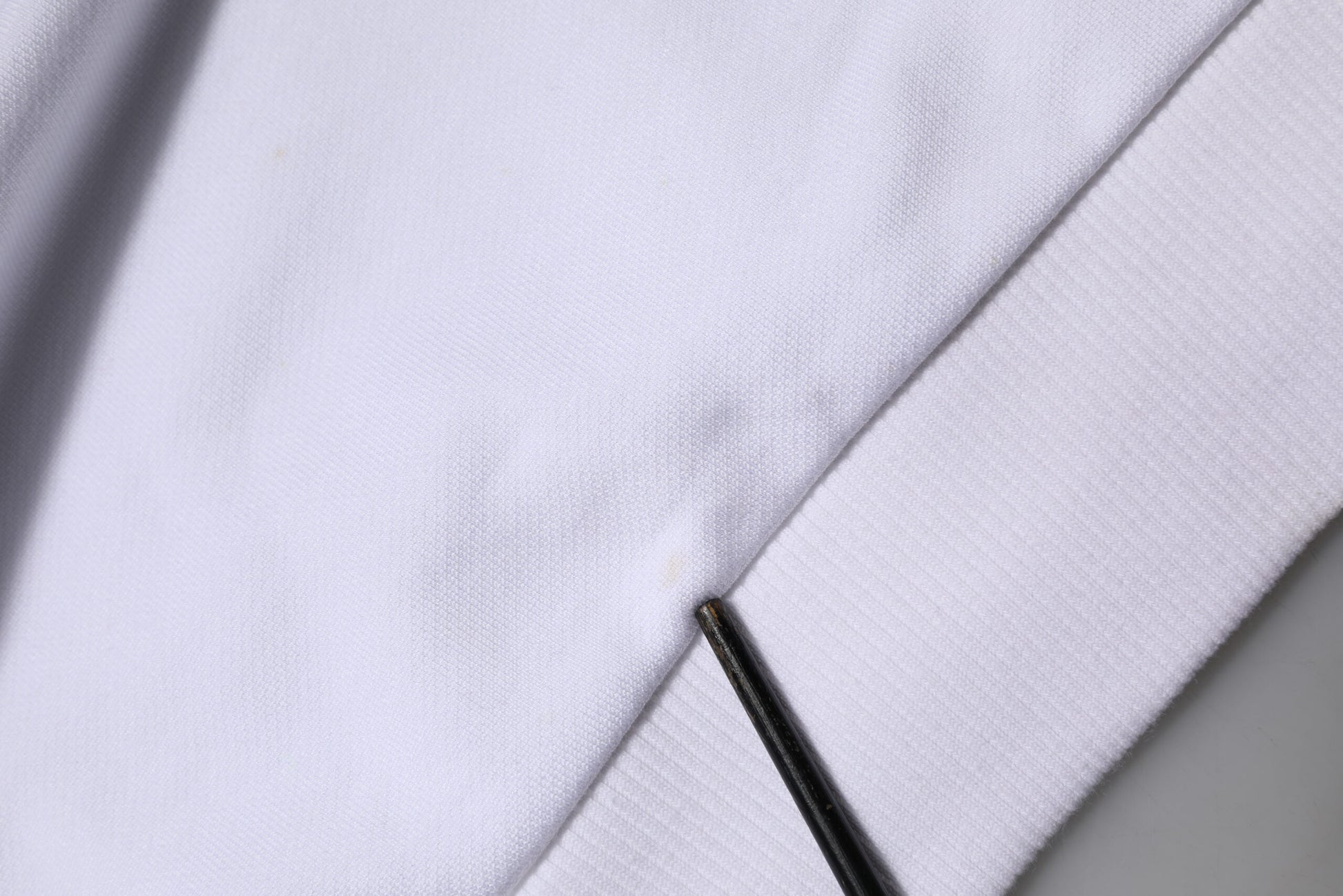 White fabric with a black zipper