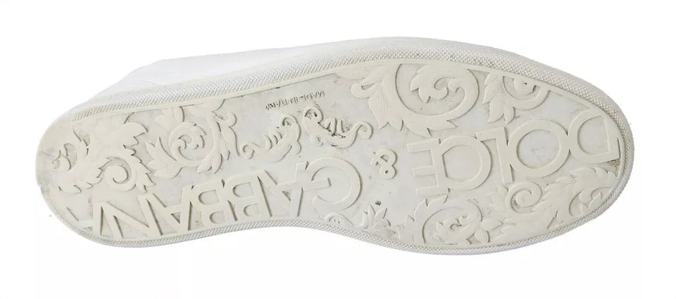 A single white men's sneaker with lace-up detail and a decorative pattern on the side