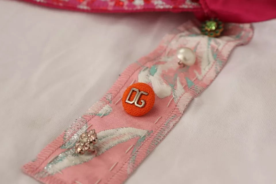 Pink fabric with buttons, pearls, and a red number six