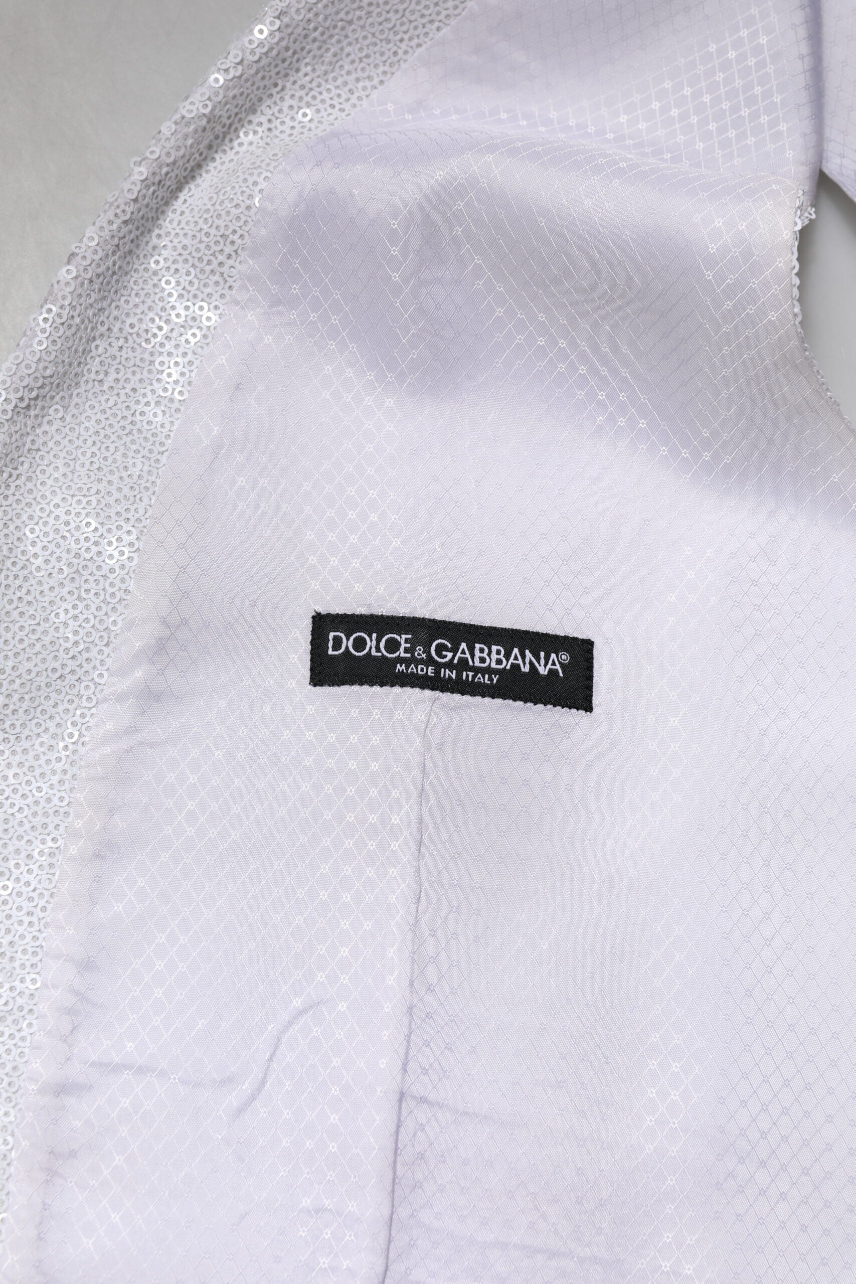 A white sequined vest from Dolce & Gabbana, part of a formal wear collection