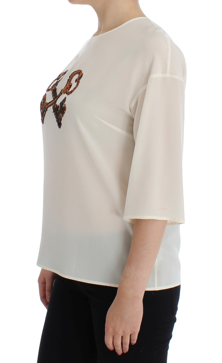 Woman wearing a long sleeve blouse with embroidered design on front