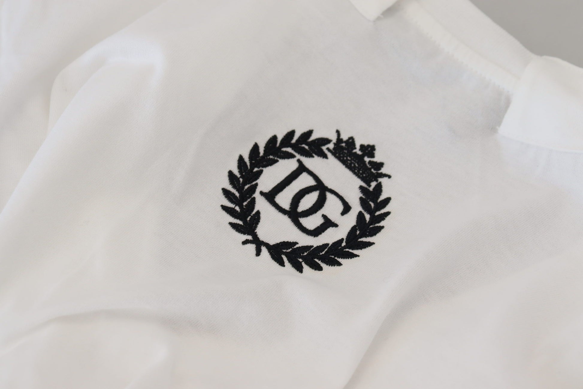 White shirt with black laurel wreath logo