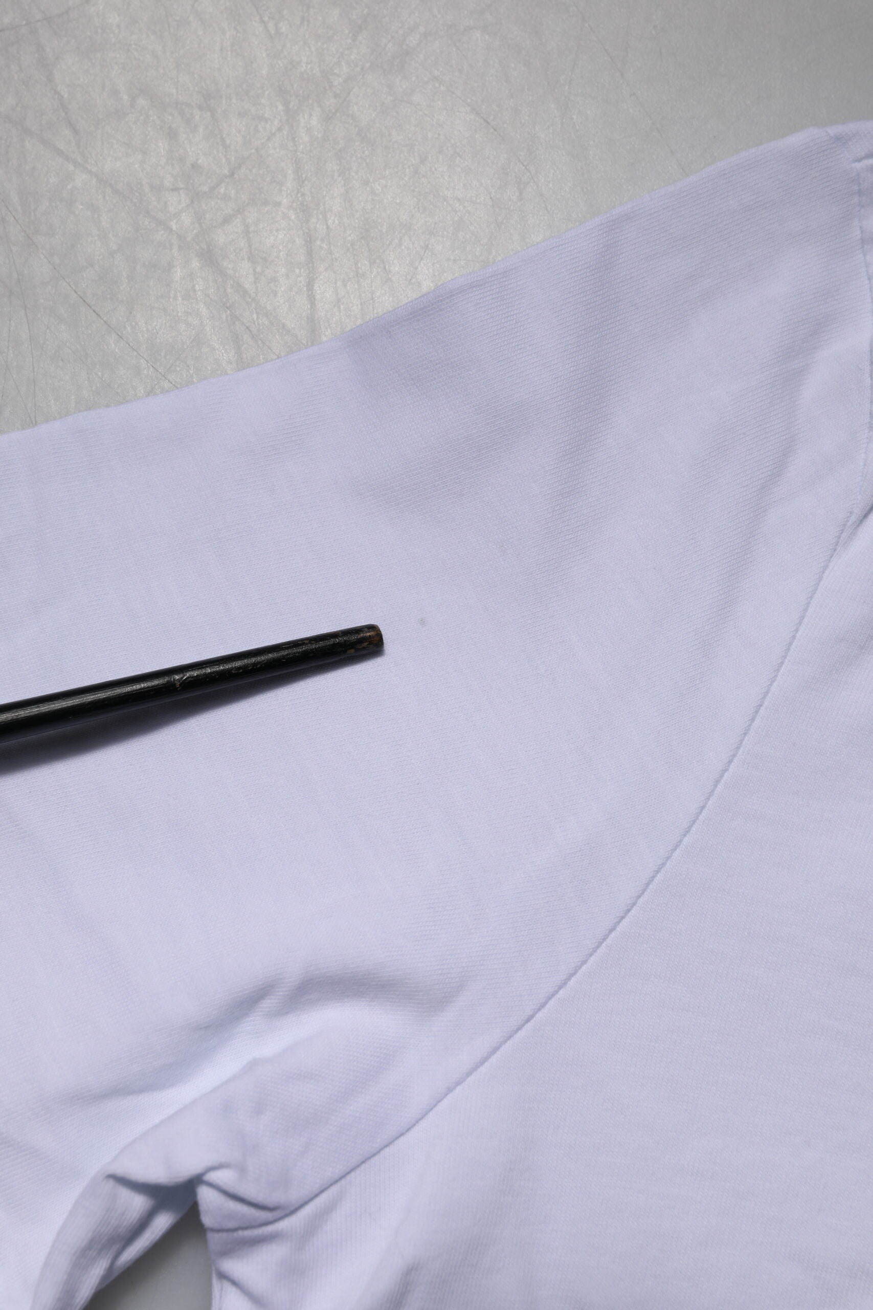 Purple scrub top on table
