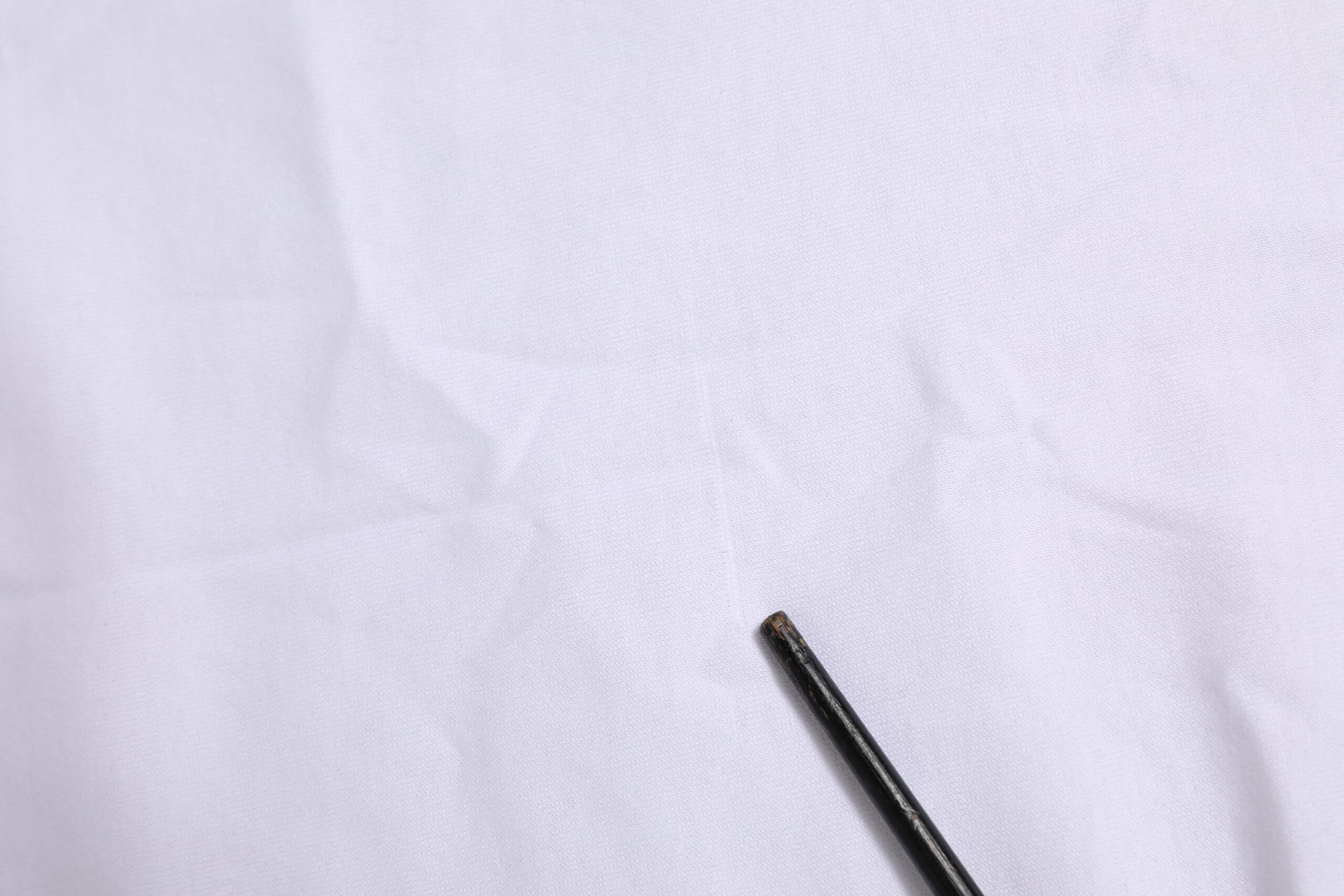 Small black object on white surface