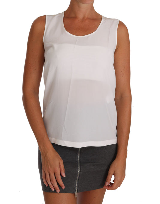 Woman wearing white tank top and gray skirt