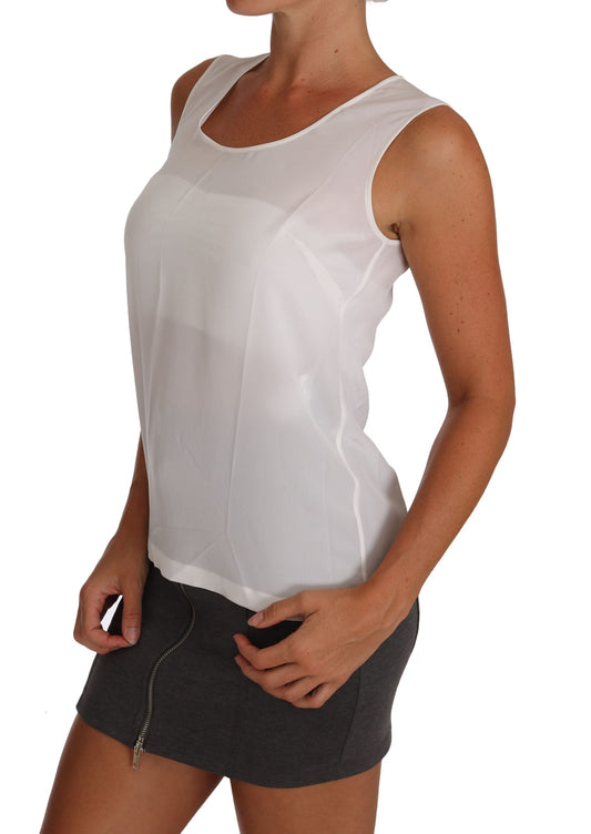 Woman wearing white tank top and gray skirt