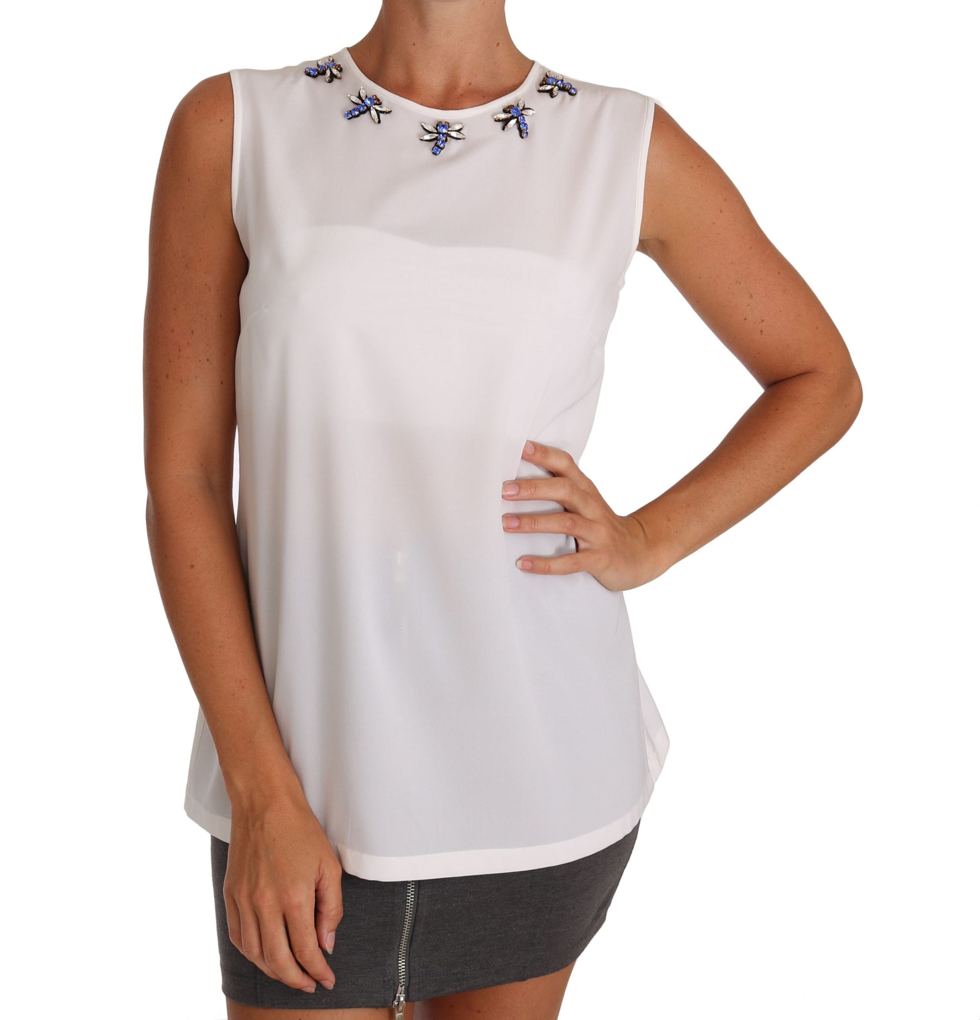 White sleeveless top with blue embellishments on shoulders