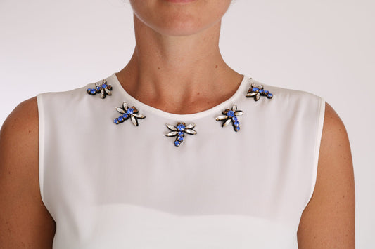 White sleeveless blouse with blue embellishments on neckline