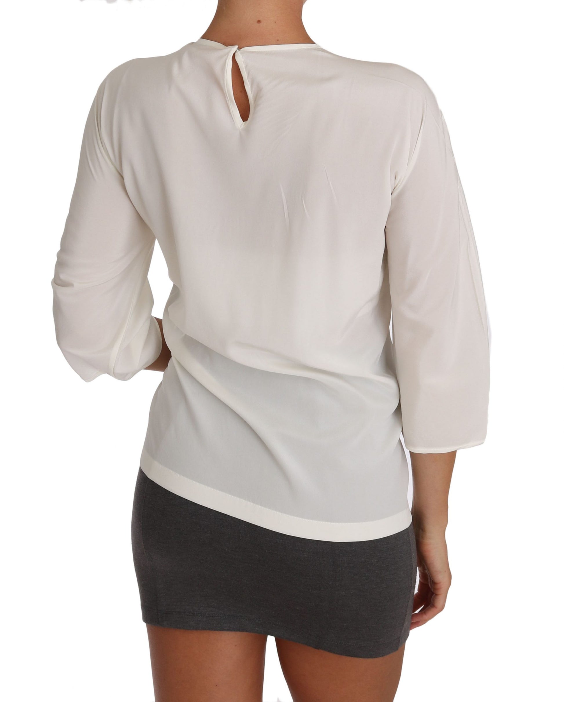 Woman wearing a long sleeve blouse and skirt
