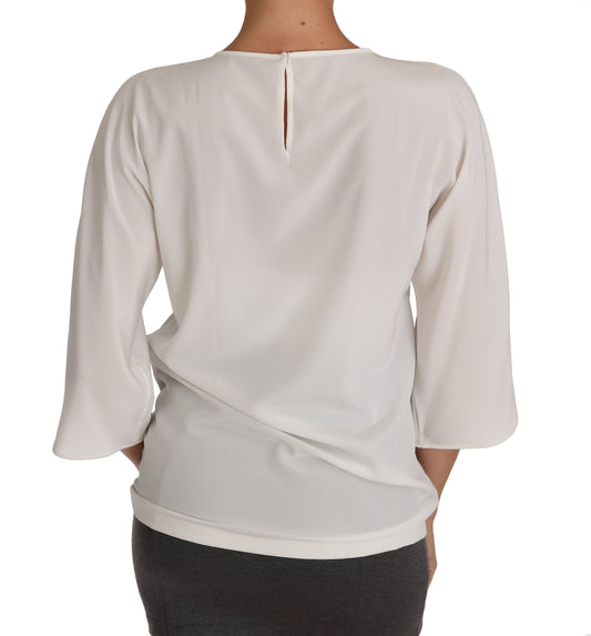 White blouse with long sleeves and a V-neckline