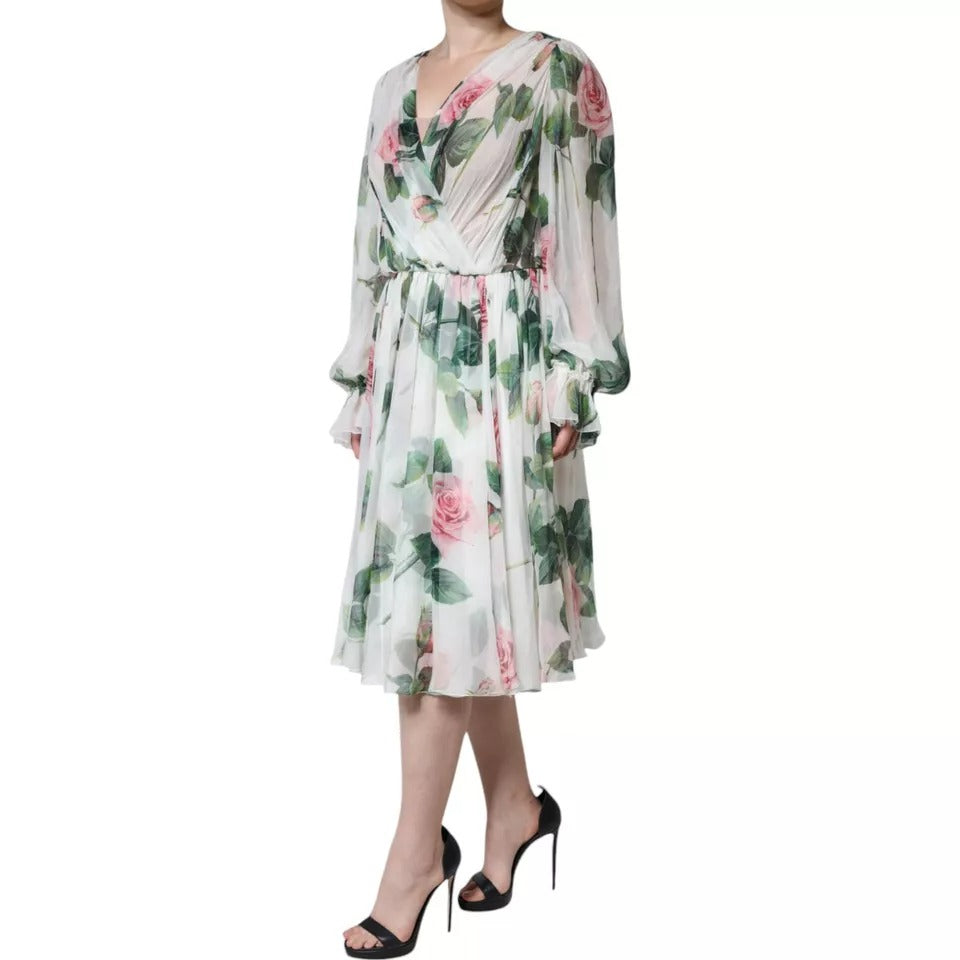 A woman wearing a white floral print midi dress with long sleeves and a belted waist