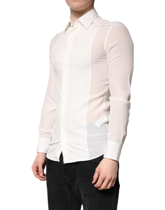 A mannequin wearing a white silk shirt with gold detailing