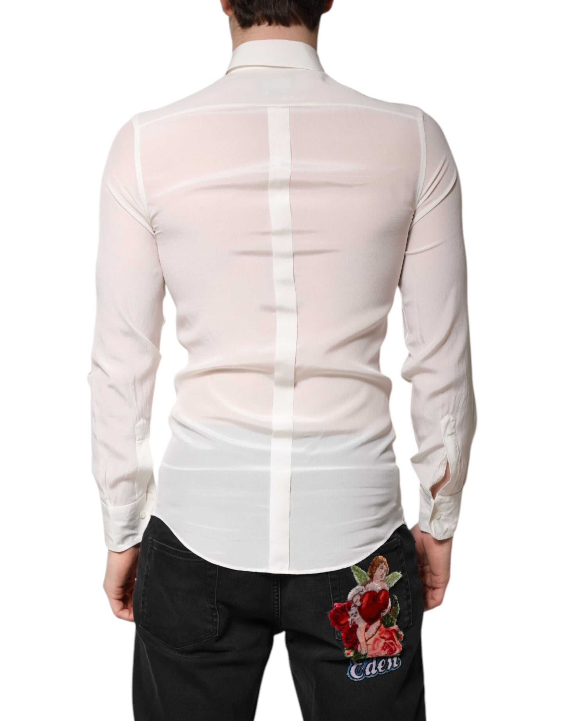 A mannequin wearing a white silk collared shirt with gold accents