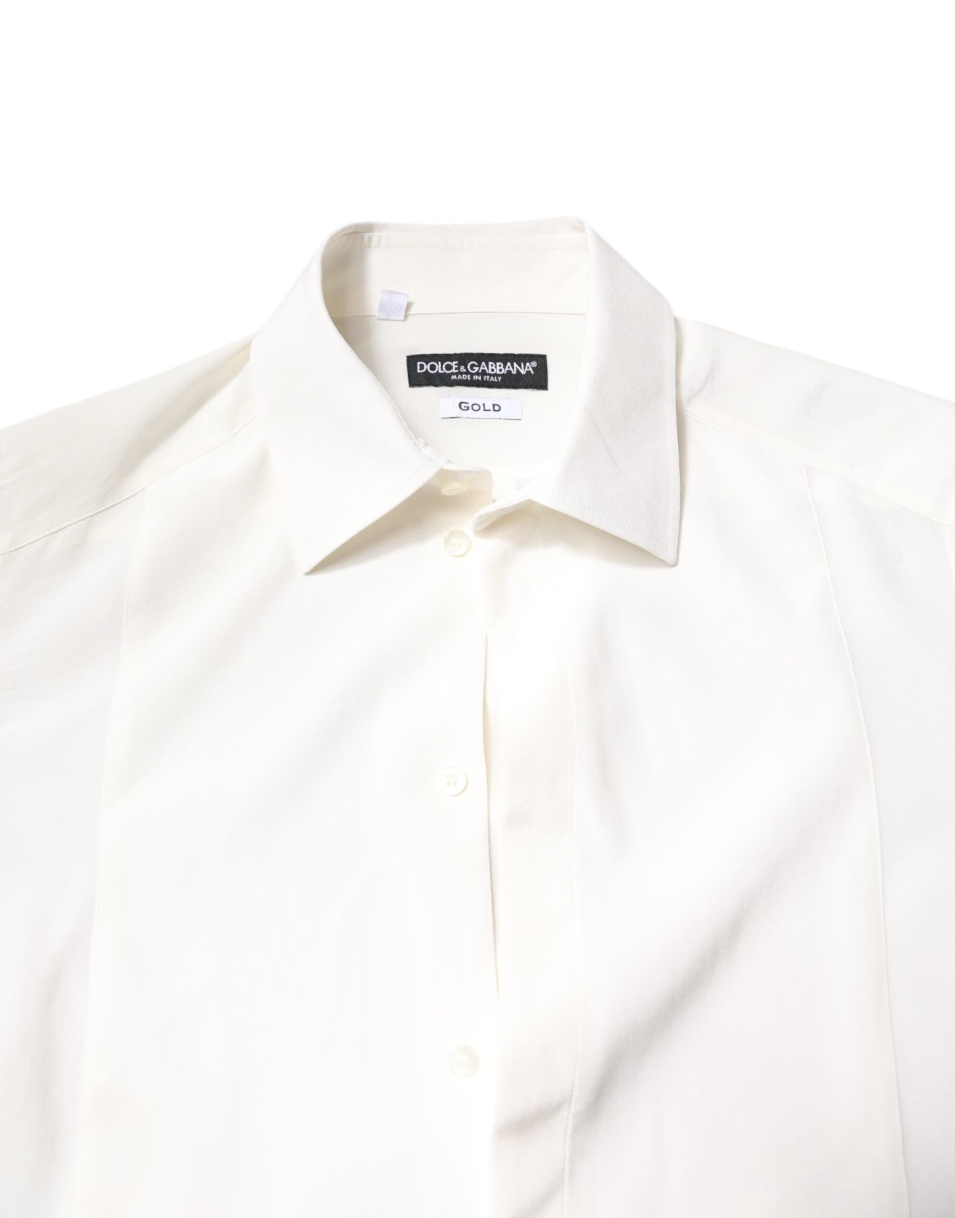 A white silk collared shirt with gold accents, part of a formal dress collection by Dolce & Gabbana