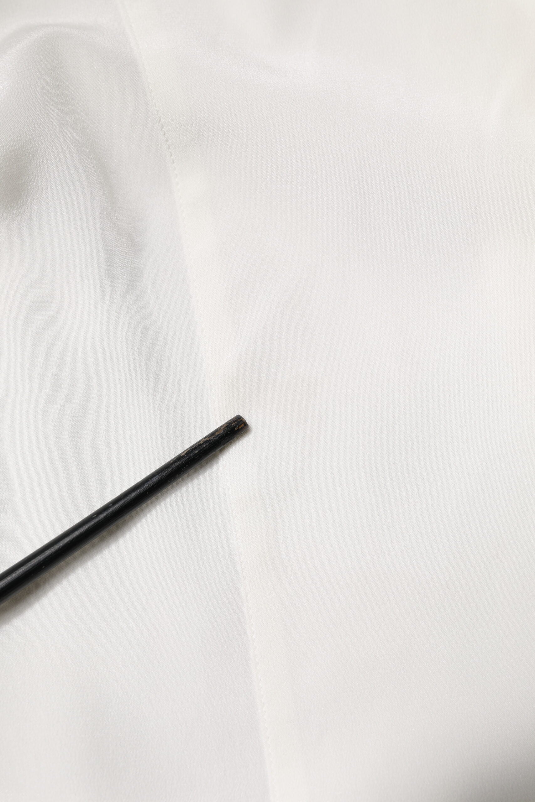 A black tie on a white silk dress shirt