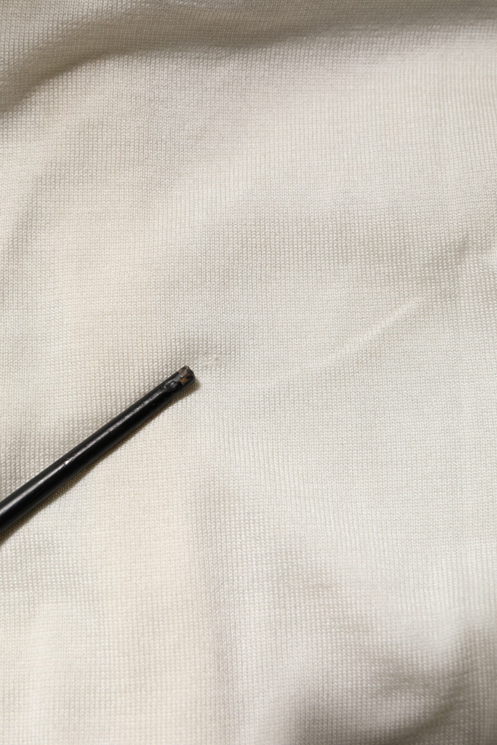 Black pen on white fabric