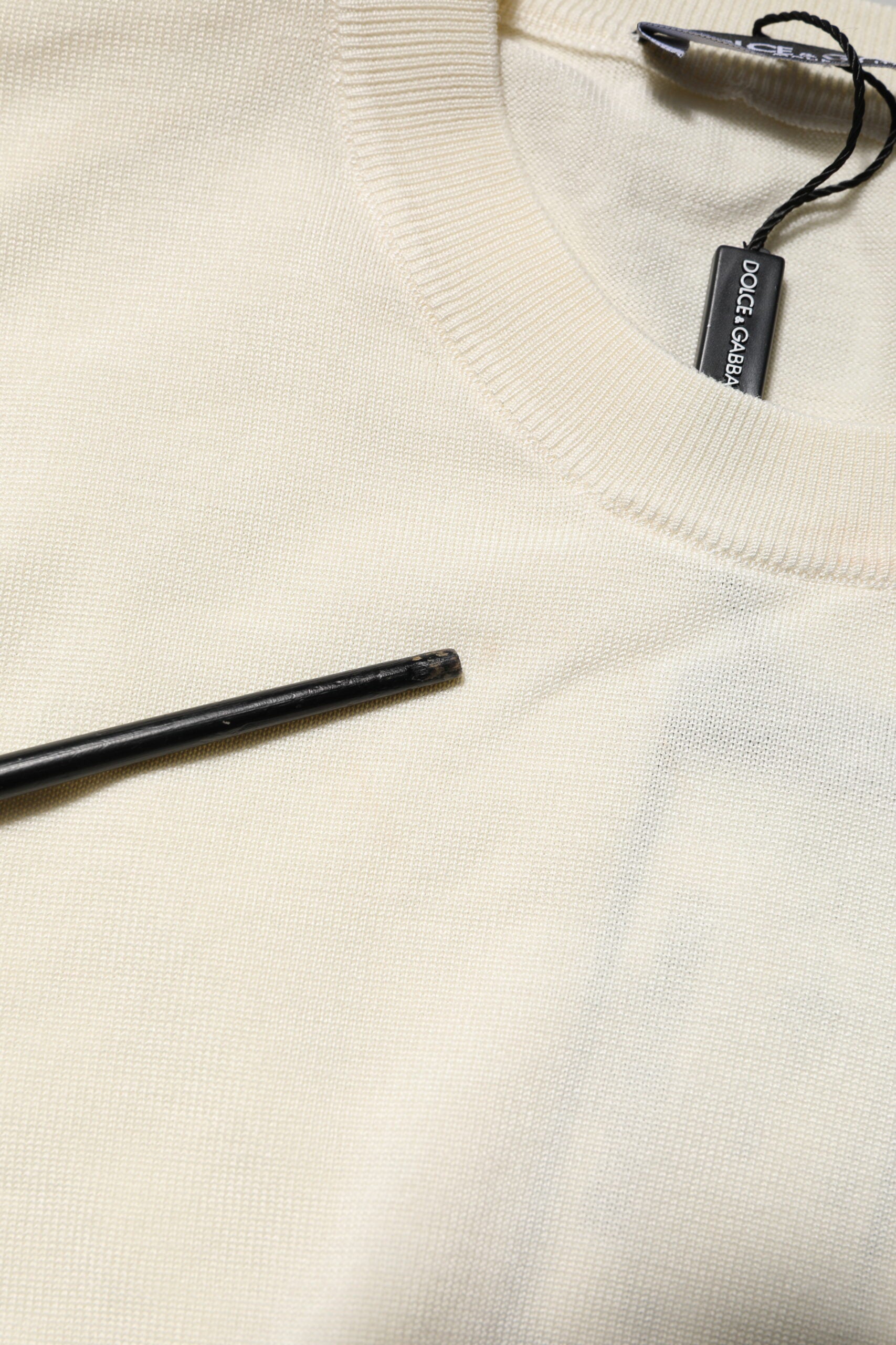 Tan sweater on hanger with black tag