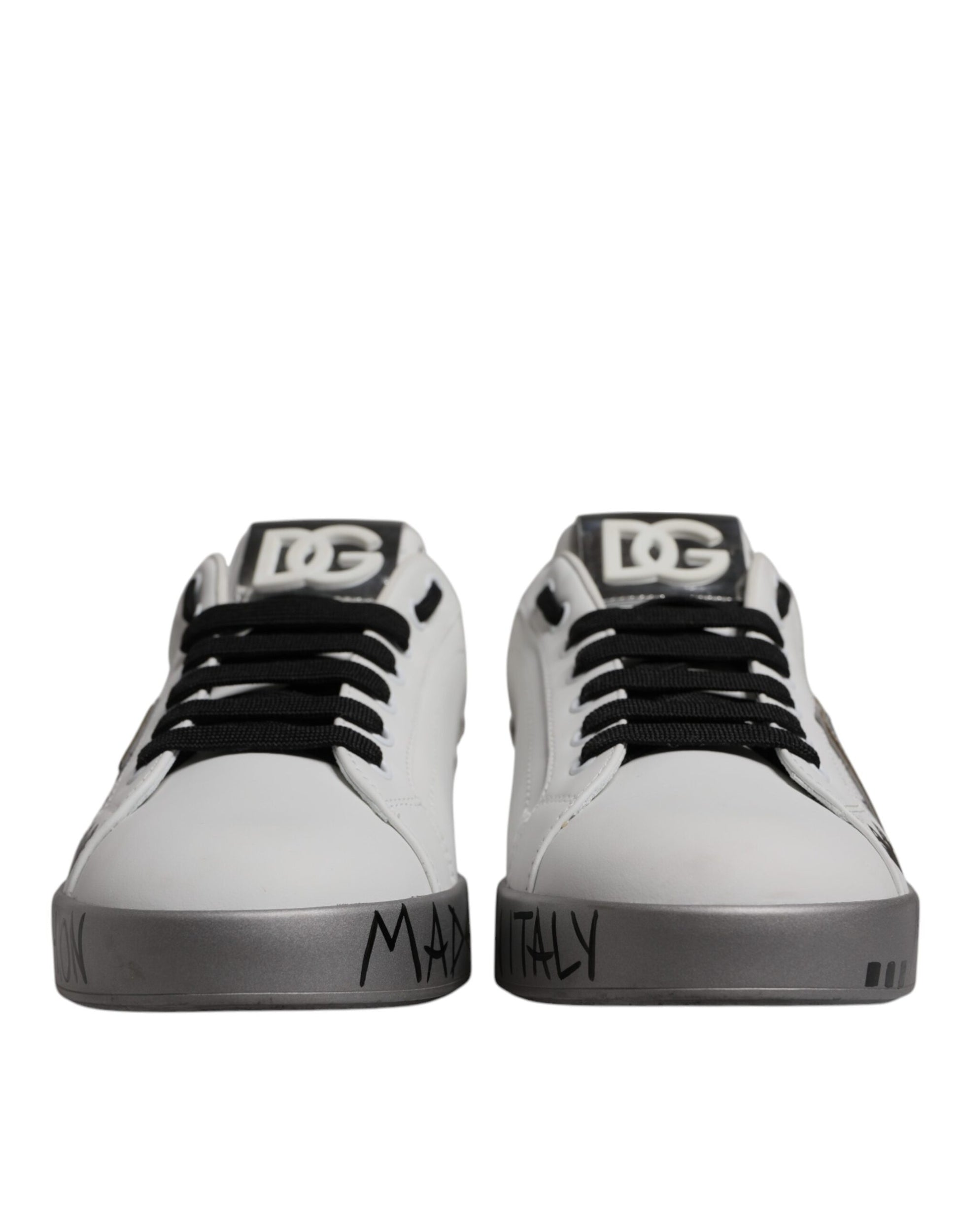 Pair of white sneakers with black laces and soles