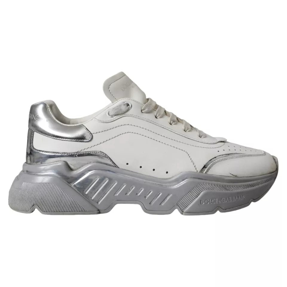 A pair of white silver sneakers with a low top, featuring the brand name "Dolce & Gabbana" on the side