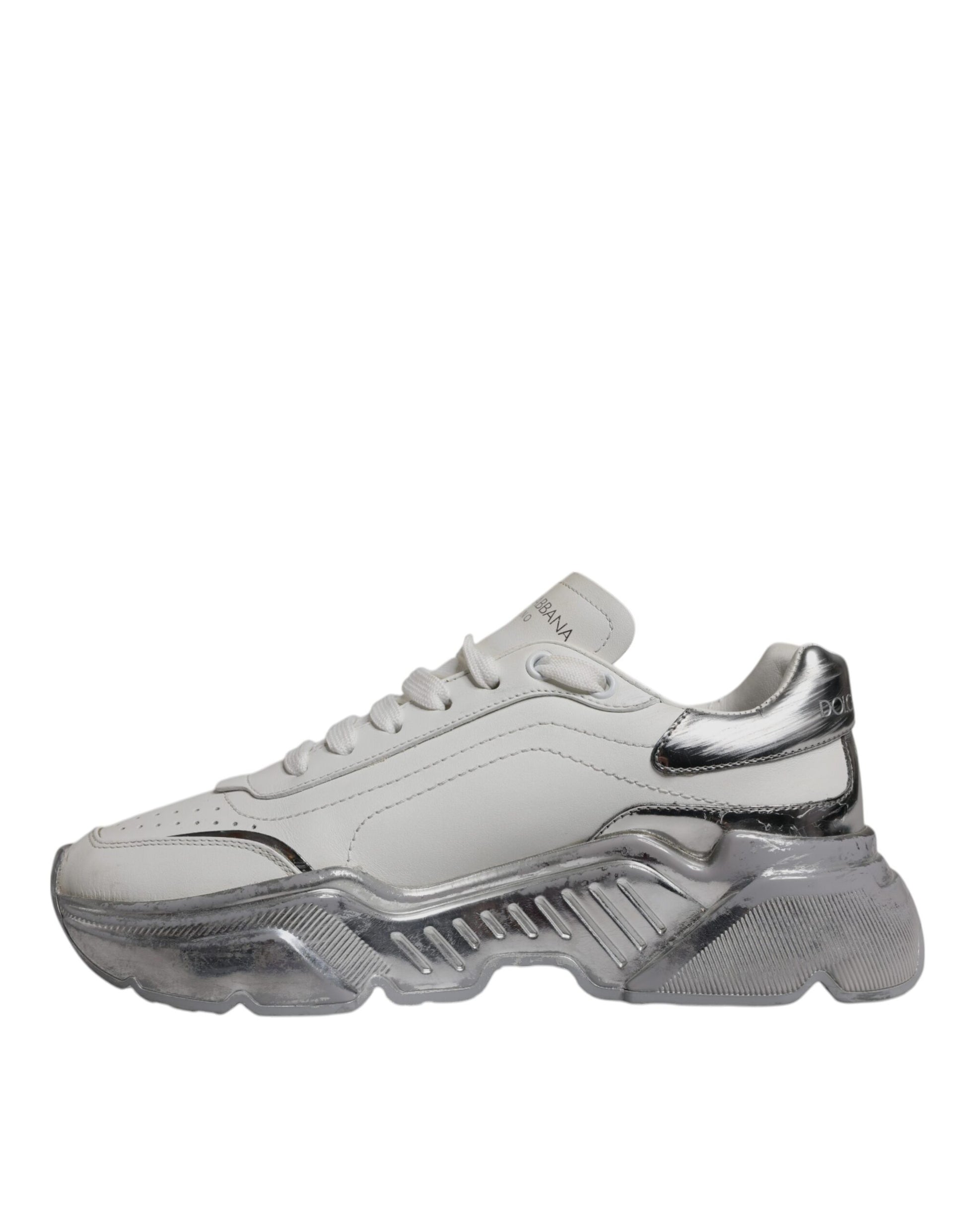 A pair of white and silver sneakers with a low top, featuring the brand logo on the side