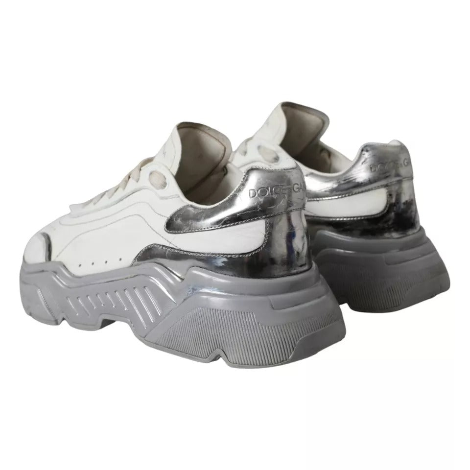 Pair of white and silver sneakers with a low top, featuring the Dolce & Gabbana logo