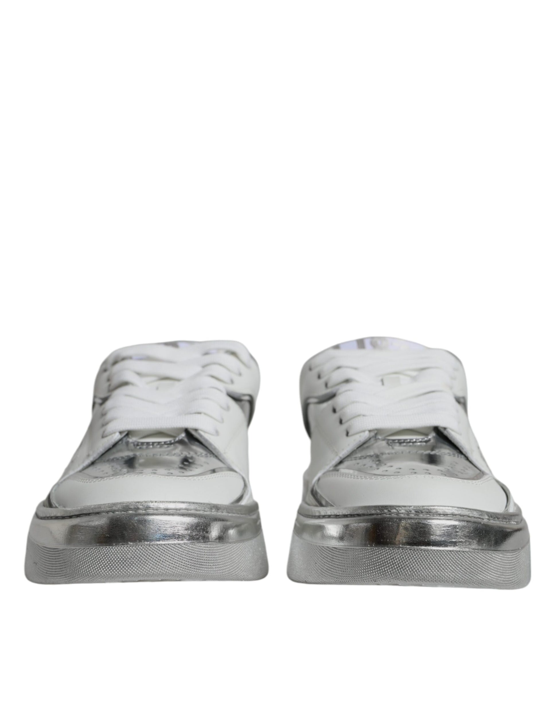 Pair of white silver leather low top sneakers with laces and a logo on the side