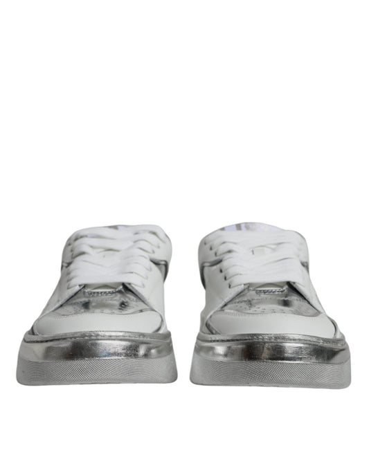 Pair of white silver leather low top sneakers with laces and a logo on the side